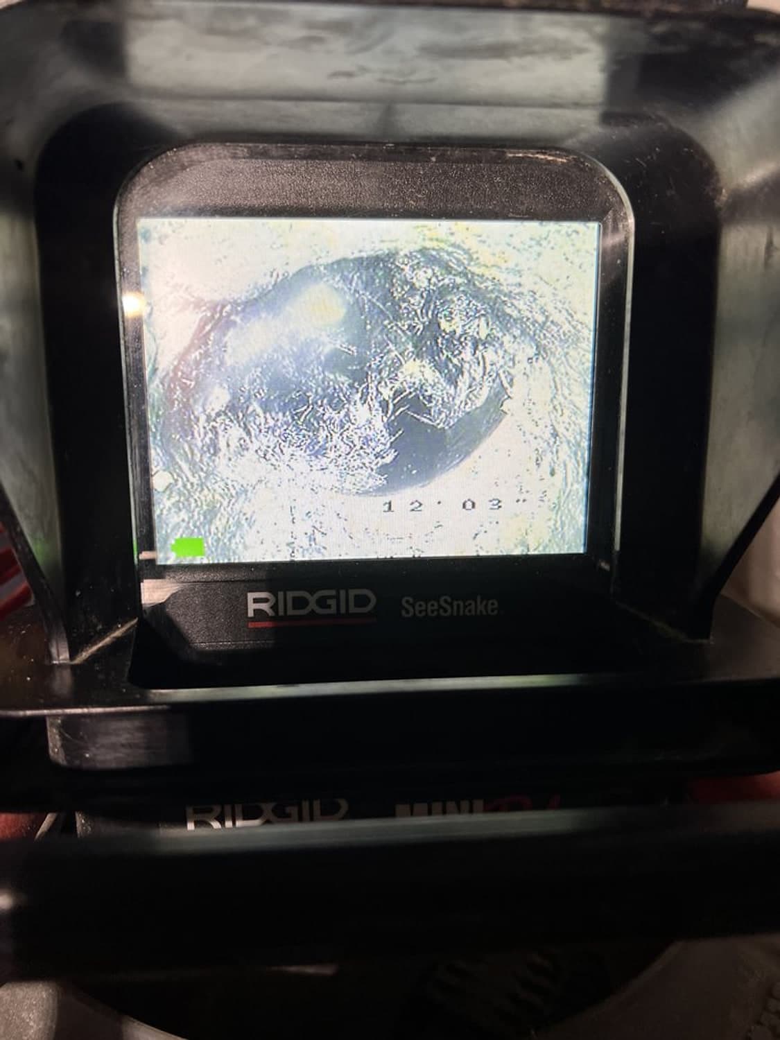 Screen of a RIDGID inspection camera showing the inside of a sewer pipe